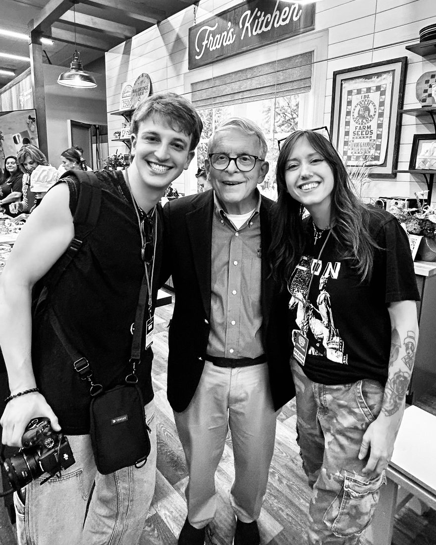 Anthony Schilt with a camera, Governor Mike DeWine, and Bridgette Kidd at the Ohio State Fair
